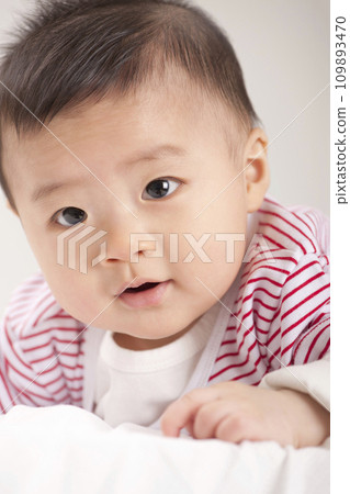 asian baby boy lying on bed 109893470