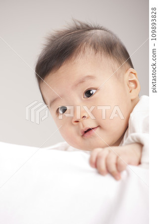 asian baby boy lying on bed asian baby boy lying on bed 109893828
