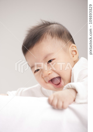 asian baby boy lying on bed asian baby boy lying on bed 109893829
