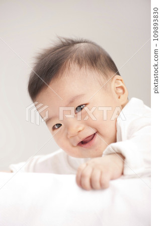 asian baby boy lying on bed 109893830