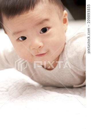 asian baby boy lying on bed asian baby boy lying on bed 109893835