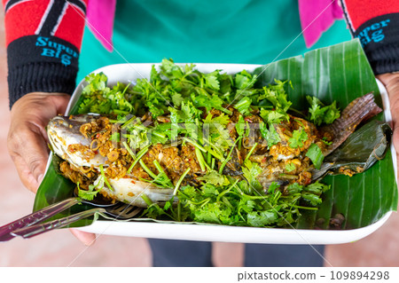 Steamed sea bass with herbs Steamed sea bass with herbs 109894298