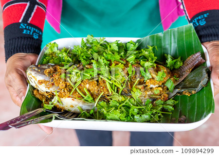 Steamed sea bass with herbs 109894299