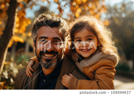 father and daughter smile and play in a park together father and daughter smile and play in a park together 109894637