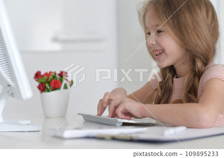 Cute and happy little girl children using laptop computer 109895233