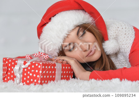 Portrait of smiling woman with Christmas gifts  109895234