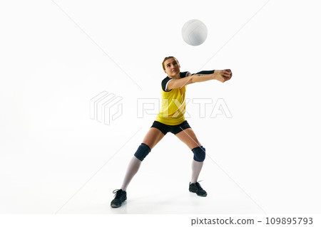 Dynamic competitive young woman, volleyball player in motion during game, hitting ball isolated over white background. Sport, active and healthy lifestyle Dynamic competitive young woman, volleyball player in motion during game, hitting ball isolated over white background. Sport, active and healthy lifestyle 109895793