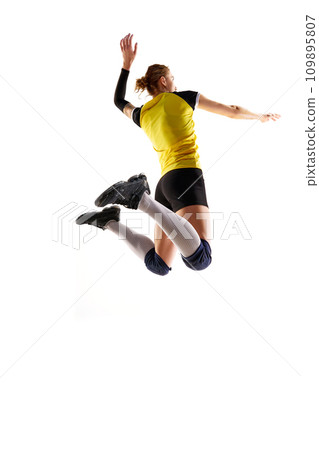 Full-length image of young athletic woman, volleyball player in motion, playing and hitting ball isolated over white background. Sport, active and healthy lifestyle Full-length image of young athletic woman, volleyball player in motion, playing and hitting ball isolated over white background. Sport, active and healthy lifestyle 109895807