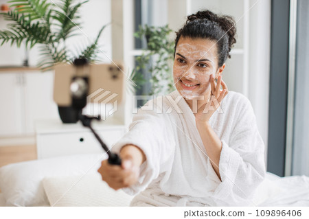 Blogger making media content applying facial mask Blogger making media content applying facial mask 109896406
