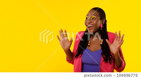 Excited Black Female Shouting Looking Aside Standing On Yellow Background 109896778