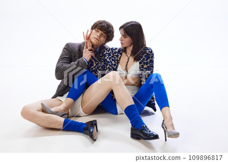 Full length portrait of young man put hand of his beloved girl to her face and closed his eyes with pleasure and enjoyment. Full length portrait of young man put hand of his beloved girl to her face and closed his eyes with pleasure and enjoyment. 109896817