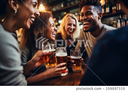 people laughing while drinking beer in a bar 109897310