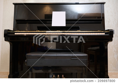 Full length still life shot of old vintage classical wooden piano in interior. Full length still life shot of old vintage classical wooden piano in interior. 109897800