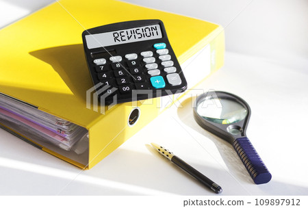 Calculator with the word REVISION. Business concept for the act of reviewing someone Calculator with the word REVISION. Business concept for the act of reviewing someone 109897912