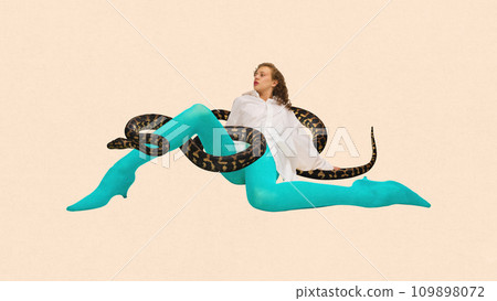 Contemporary art collage. Weird woman in white blouse and blue tights sitting with snake in her legs against peach color background. Contemporary art collage. Weird woman in white blouse and blue tights sitting with snake in her legs against peach color background. 109898072