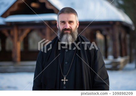 Serene Priest in Black Robe Outdoors 109898209