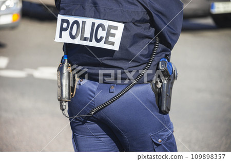 French police lady with "POLICE" written on the back of her uniform. French police lady with "POLICE" written on the back of her uniform. 109898357