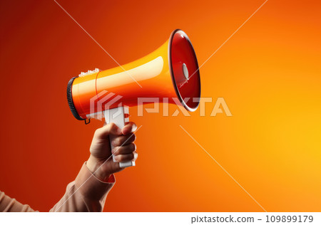Megaphone in hand on a orange background, attention concept announcement Megaphone in hand on a orange background, attention concept announcement 109899179
