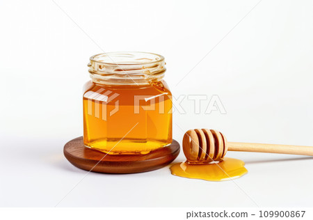 glass jar full of honey and dipper isolated on white background glass jar full of honey and dipper isolated on white background 109900867