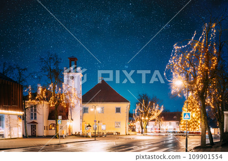 Kuressaare, Estonia. Building Of Fire Bell Tower And Kuressaare Town Hall In Evening Christmas Xmas New Year Illuminations. Amazing Bold Bright Blue Starry Sky Gradient Above Fire Bell Tower Kuressaare, Estonia. Building Of Fire Bell Tower And Kuressaare Town Hall In Evening Christmas Xmas New Year Illuminations. Amazing Bold Bright Blue Starry Sky Gradient Above Fire Bell Tower 109901554