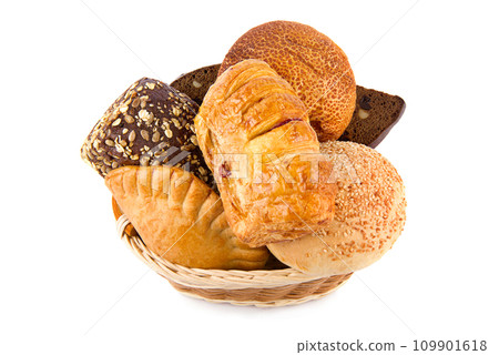 Buns and sweet pastries in a wicker basket isolated on white. 109901618