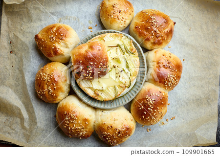 closeup of freshly baked bread buns with melted brie closeup of freshly baked bread buns with melted brie 109901665