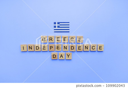 March 25, Independence Day in Greece, the flag of Greece, a minimalistic banner with an inscription in wooden letters 109902043