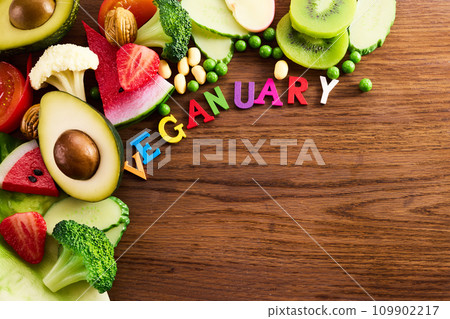 Vegetarian and vegan diet month in january called Veganuary. healthy raw vegetables and fruits on wooden background. Vegetarian and vegan diet month in january called Veganuary. healthy raw vegetables and fruits on wooden background. 109902217