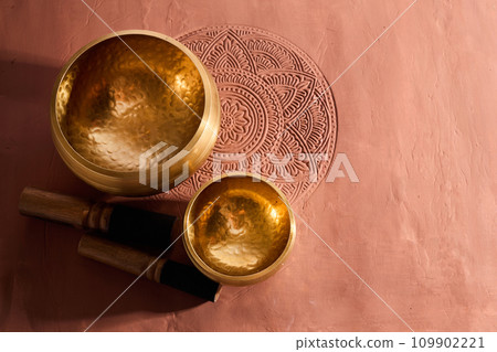 A close up of a tibetan singing bowl or himalayan bowl for therapy, meditation and relaxation. A close up of a tibetan singing bowl or himalayan bowl for therapy, meditation and relaxation. 109902221