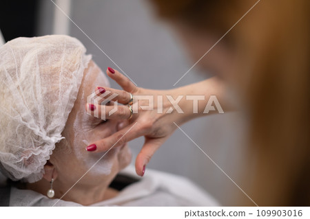 An elderly woman undergoes beauty treatments at a beauty salon An elderly woman undergoes beauty treatments at a beauty salon 109903016