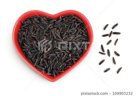 Black rice in a red ceramic bowl isolated on white background. Top view. Flat lay 109903232