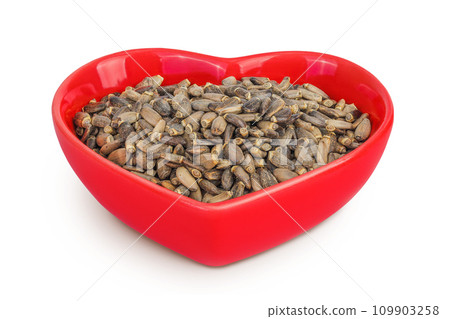 Seeds of a milk thistle or Silybum marianum, Scotch Thistle, Marian thistle in ceramic bowl isolated on white background 109903258