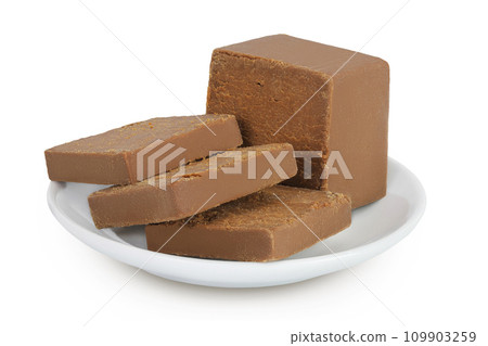 Brown cheese. Norwegian brunost in a ceramic bowl isolated on white background with full depth of field 109903259