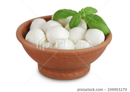 Mini mozzarella balls with basil leaf in a ceramic bowl isolated on white background with full depth of field. Mini mozzarella balls with basil leaf in a ceramic bowl isolated on white background with full depth of field. 109903279