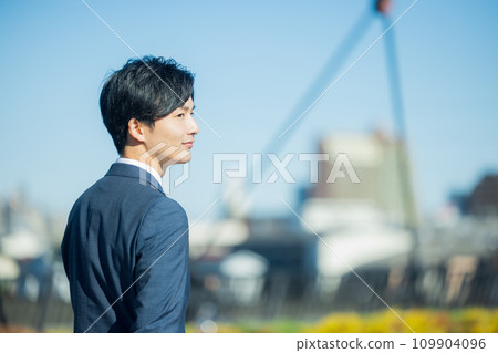 young man wearing a suit young man wearing a suit 109904096