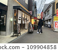 Couple looking for a restaurant in a back alley, Tenma, Osaka 109904858