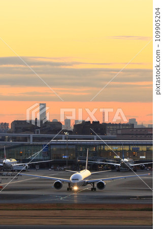 Passenger plane departing against the sunset background Passenger plane departing against the sunset background 109905204