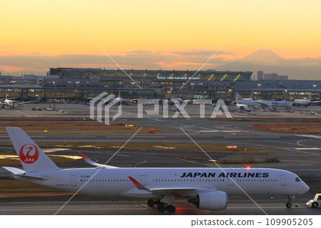 Passenger plane departing against the sunset background 109905205