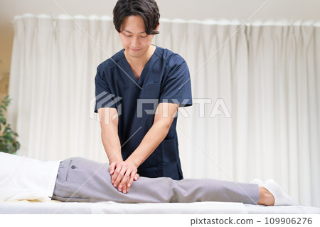 Young male chiropractor performing treatment 109906276