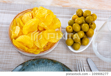 Chips and olives served in bowl for snack 109906277
