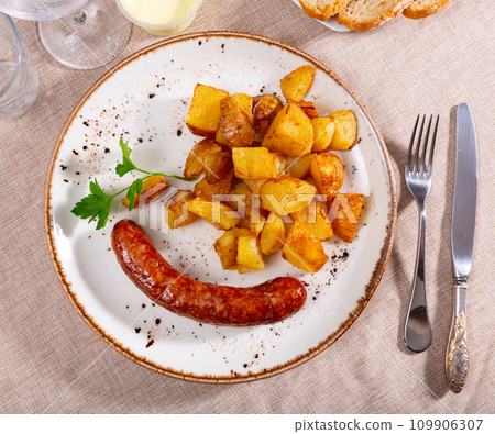 Sausages with potatoes and spicy aioli. Traditional spanish dish Sausages with potatoes and spicy aioli. Traditional spanish dish 109906307