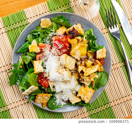 Caesar salad with chicken breast, lettuce, sauce and cheese 109906371