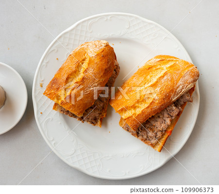 Sandwiches with sausage and grated tomatoes, served with cups of coffee closeup 109906373
