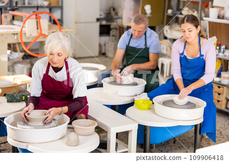 lady works on potter's wheel 109906418