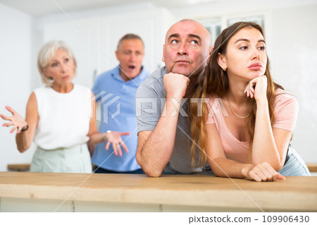 Portrait of an offended couple, which mature family members reprimand Portrait of an offended couple, which mature family members reprimand 109906430