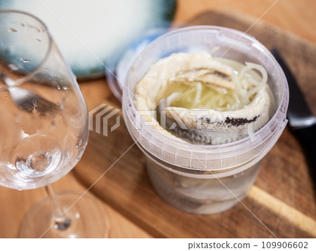 In plastic bucket containers are large pieces of salted herring fillet, freed from bones In plastic bucket containers are large pieces of salted herring fillet, freed from bones 109906602