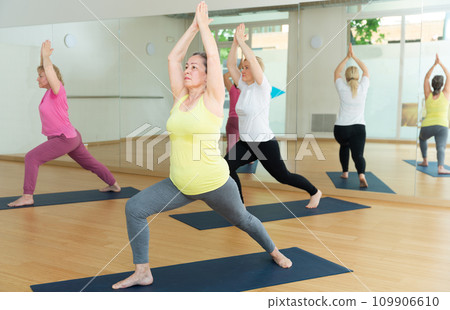 Women are doing warrior I pose 109906610