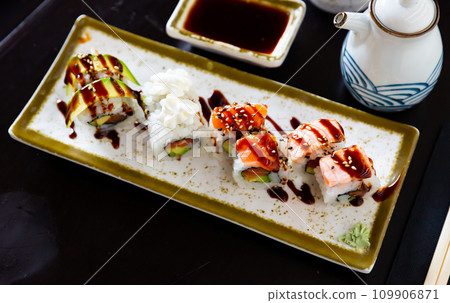 Japanese Uramaki and California rolls served in a plate with soya sauce 109906871