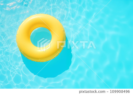 Top View Yellow Swimming Pool Ring Float in Blue Water,Summertime Relaxation 109908496