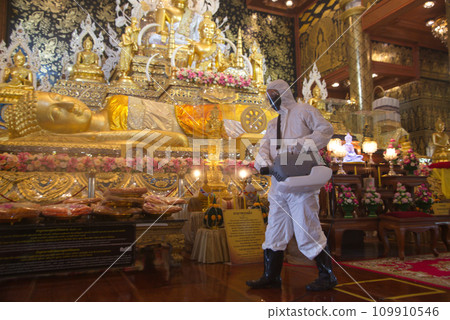 A male employee is spraying medicine to eliminate germs from a sprayer to eliminate Covid-19. At Wat Tha Mai temple. A male employee is spraying medicine to eliminate germs from a sprayer to eliminate Covid-19. At Wat Tha Mai temple. 109910546